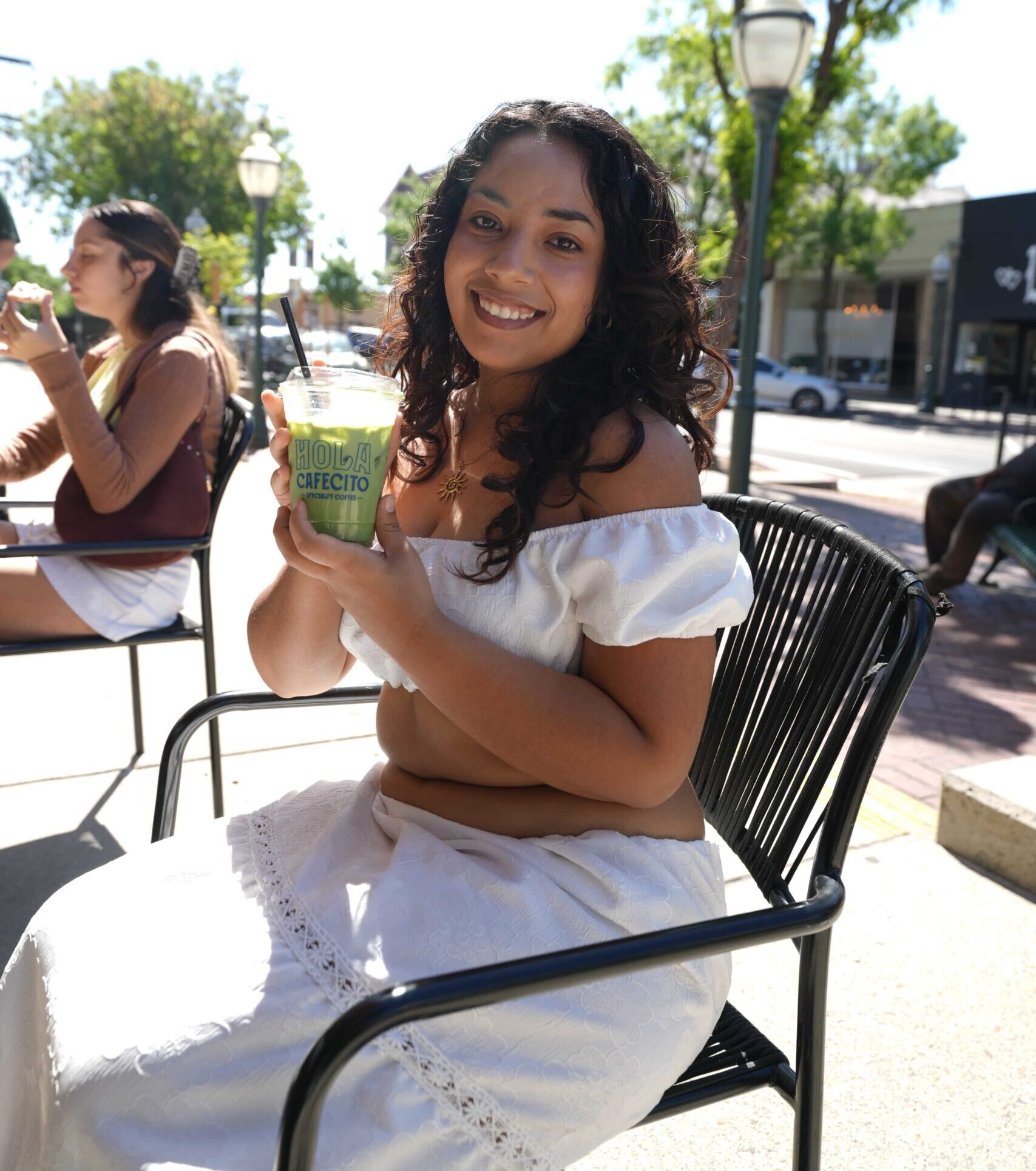 A happy visitor enjoying a smoothie in Merced